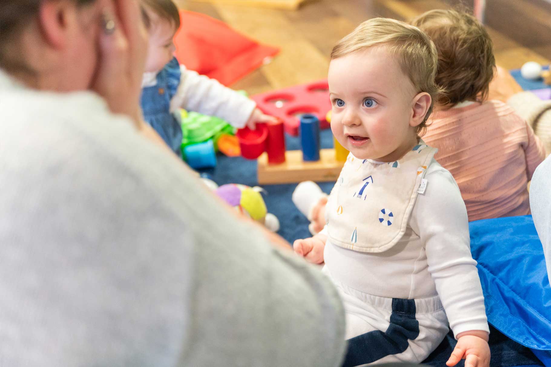Young baby watching an adult play peek-a-boo