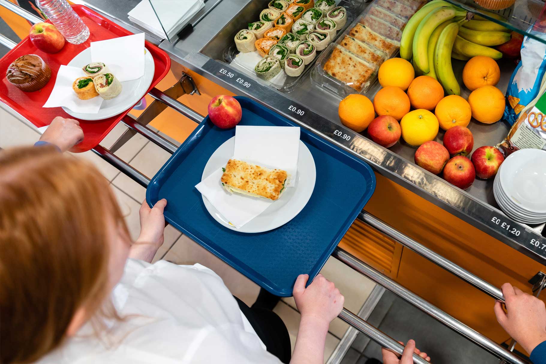 Children making healthy choices in school dinner queue