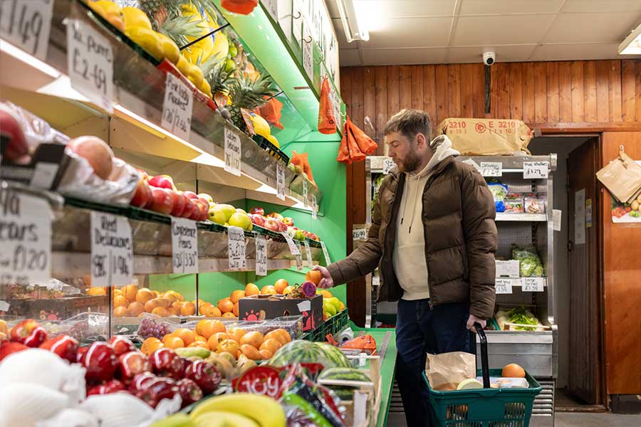 A man buying fruit and vegetables in a local fruit and veg shop